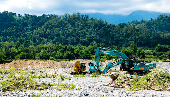 Stone mining operations in progress on the Saralbhanga river on the Bhutanese side of the river.