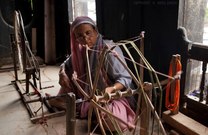A woman spinning a traditional 'charkha' or a spinning wheel (Image by Nevil Zaveri)