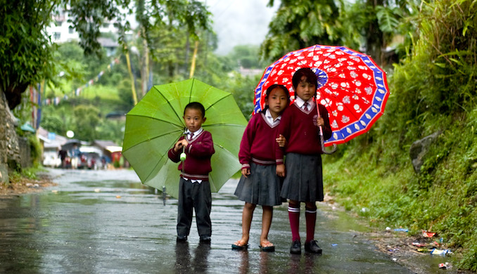 Children walking in the rain in Sikkim. (image by Marina Shakleina) 
