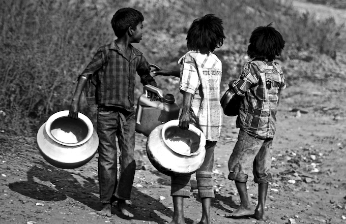 Tetulmari, Dhanbad, February 2, 2016: Boys overcome the problems of contaminated and scarce water by collecting drinking water from a damaged pipeline.