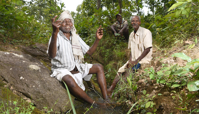 The jovial pani baba with his fellow villagers in a small water stream in the woodland near Gaighat dam. This rivulet is used to distribute water from the reservoir