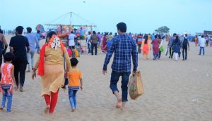 A man carrying stuff in a jute bag as he enters into Chennai’s Marina Beach along with his family. Marina beach is one of the most polluted beaches in India.