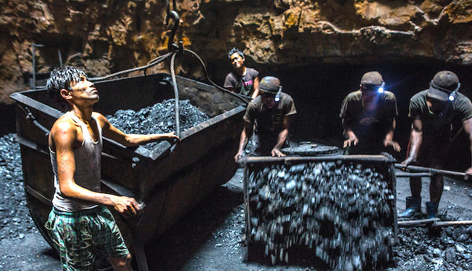 Coal is lifted out of a mine shaft in India (Photo by Robb Kendrick/Alamy)